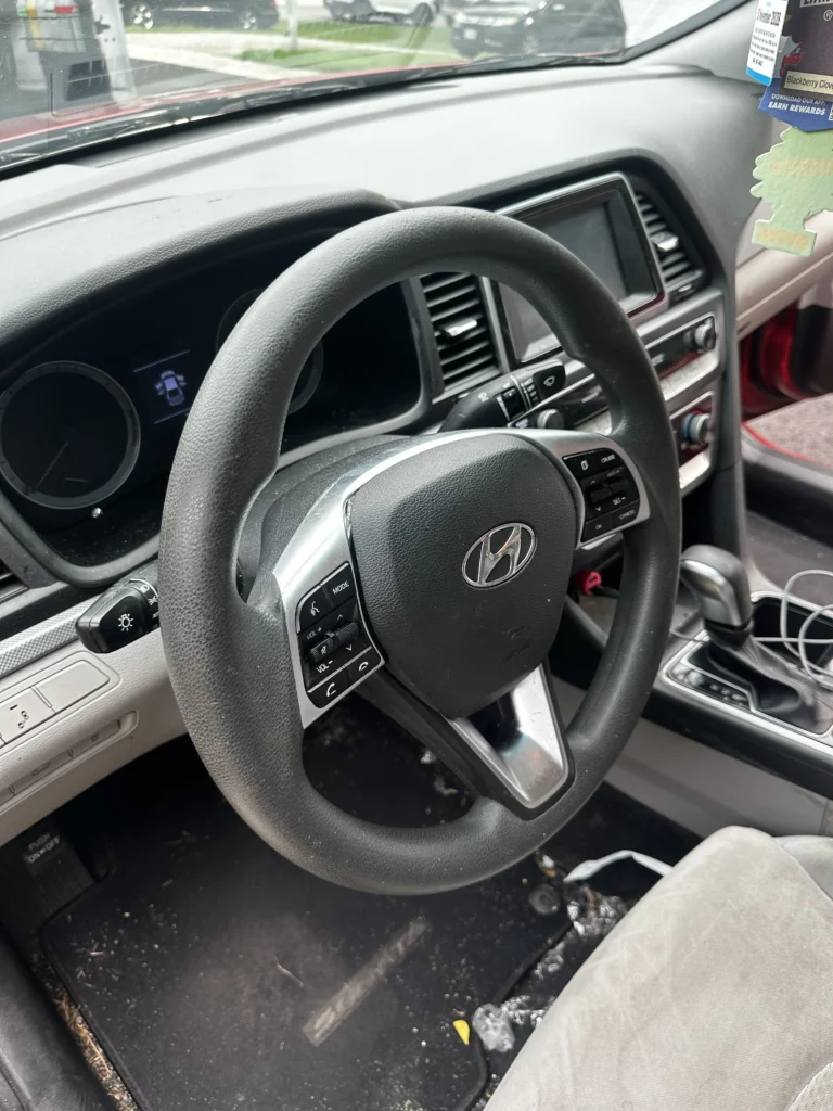 Car interior before detailing — dirty seats and console